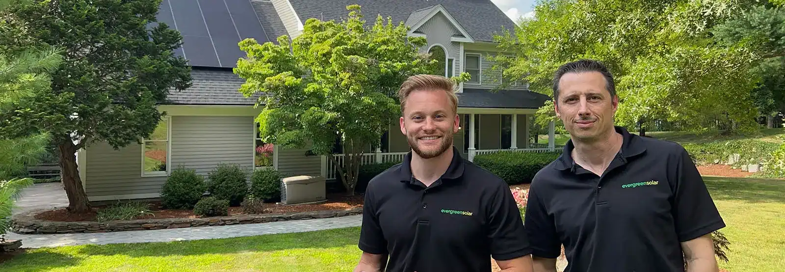 Brian Fabiano and Patrick from Evergreen Solar in front of a home with solar panels