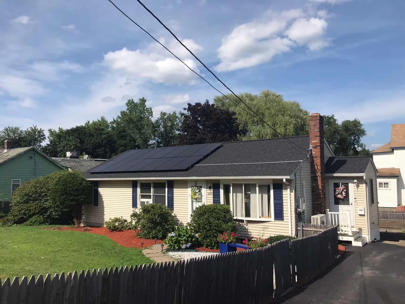 Solar panels installed on the roof of a suburban house, capturing sunlight to generate renewable energy, promoting eco-friendly living and reducing electricity costs.