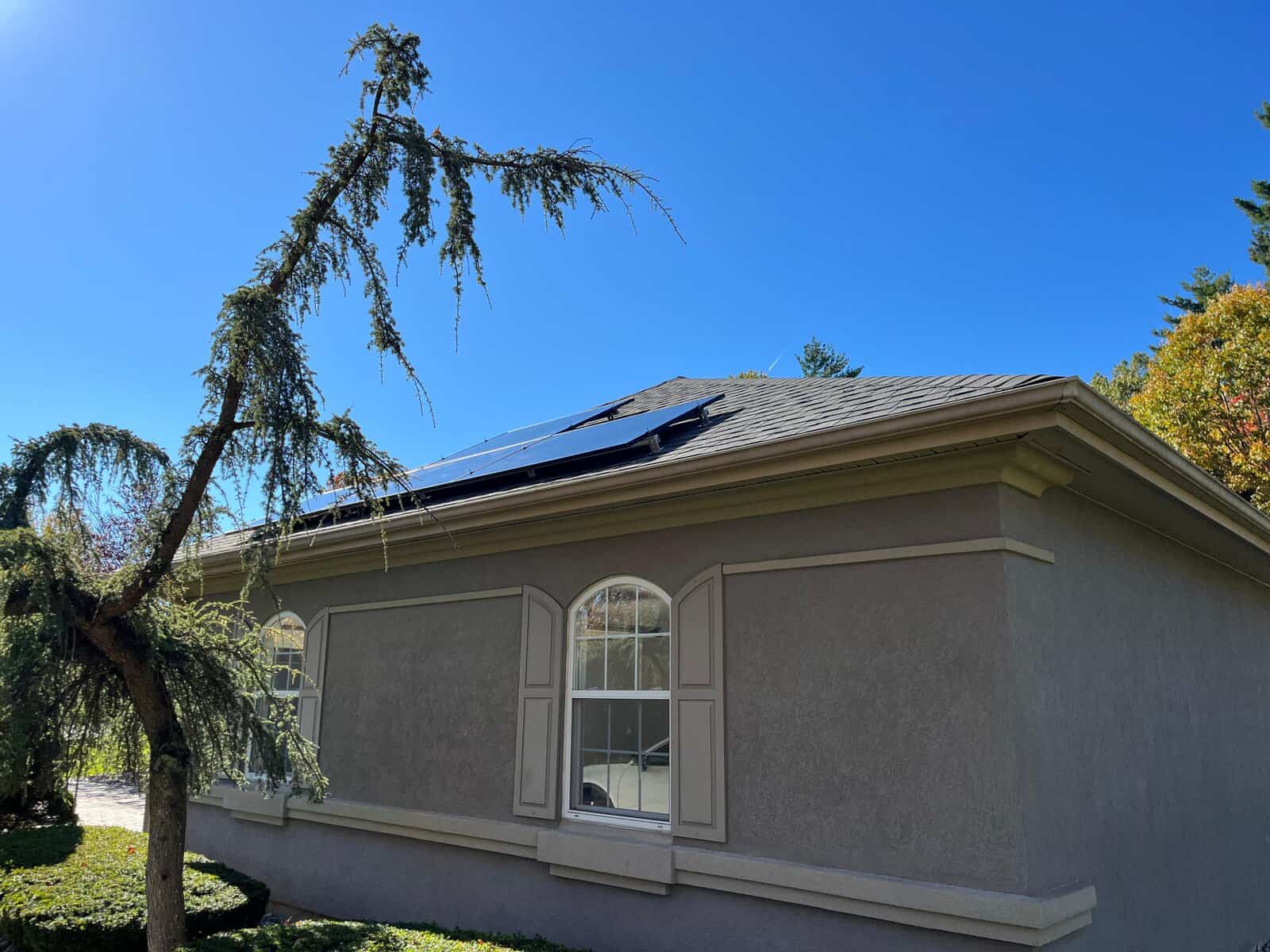 Side view of a residential home with rooftop solar panels installed, highlighting clean energy production, solar power savings, and a professionally integrated solar system designed for long-term energy efficiency.