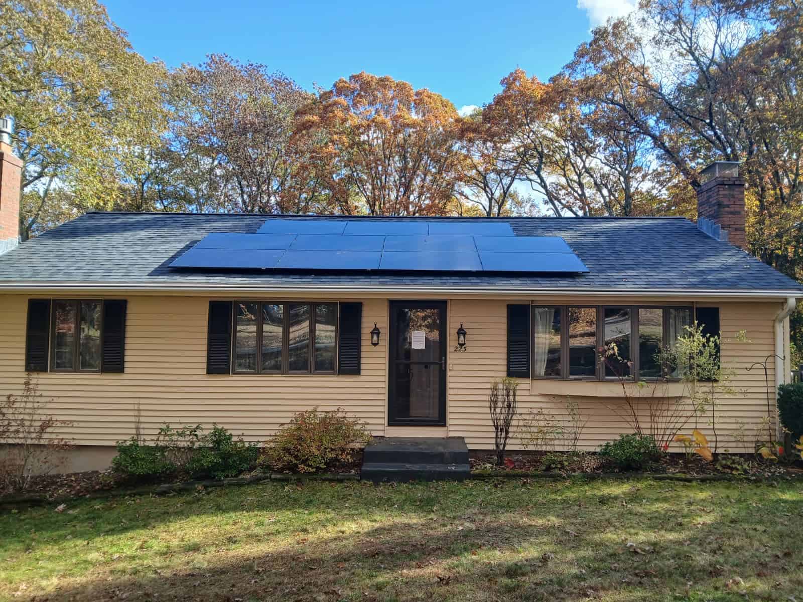 Front view of a single-story New England home with rooftop solar panels installed, highlighting residential solar installation, clean energy use, and long-term solar savings for homeowners.