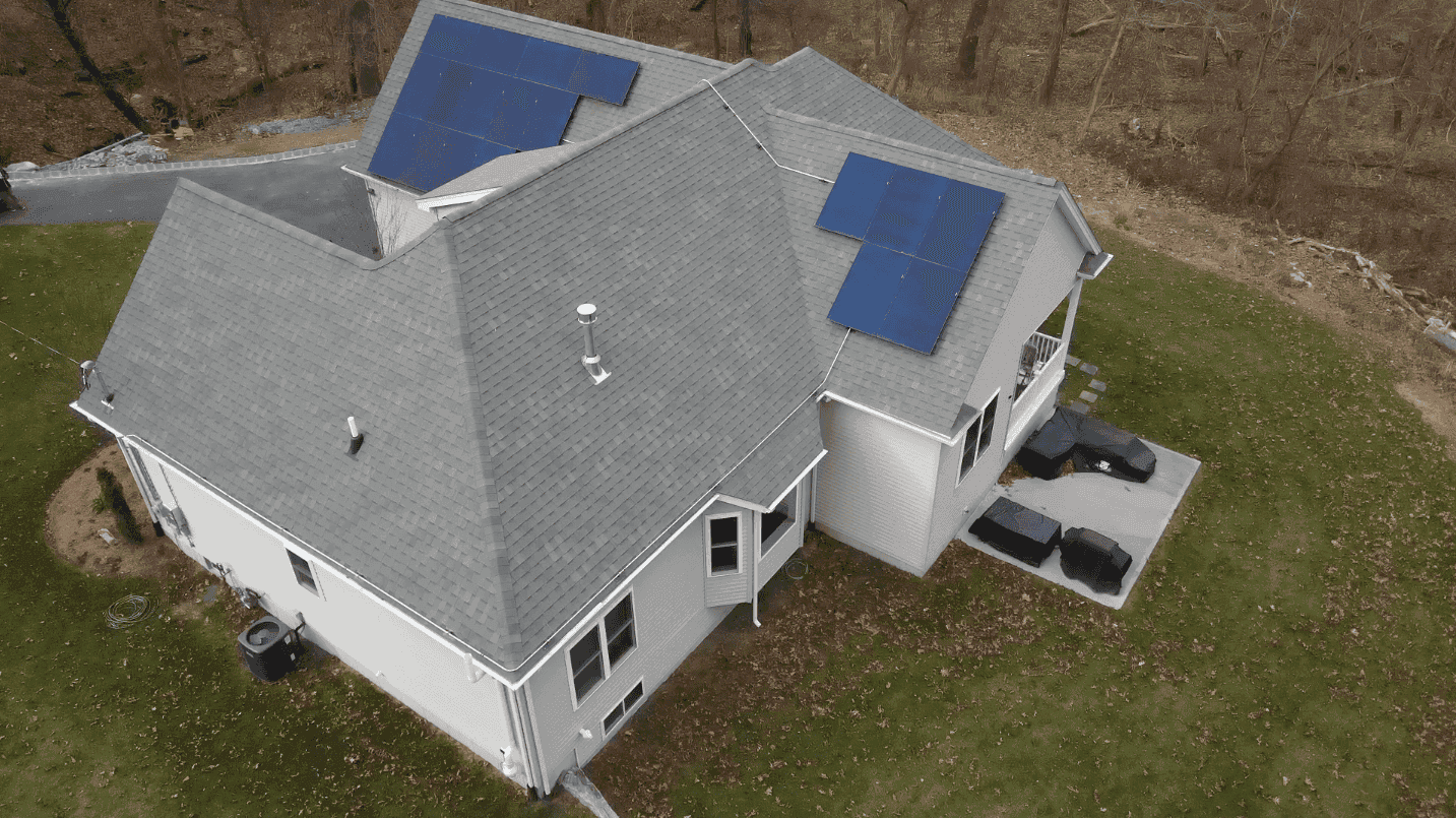 Solar panel installation on residential roof with multiple panels, energy-efficient home solar system, renewable energy, eco-friendly solar power array, sustainable home energy solutions.
