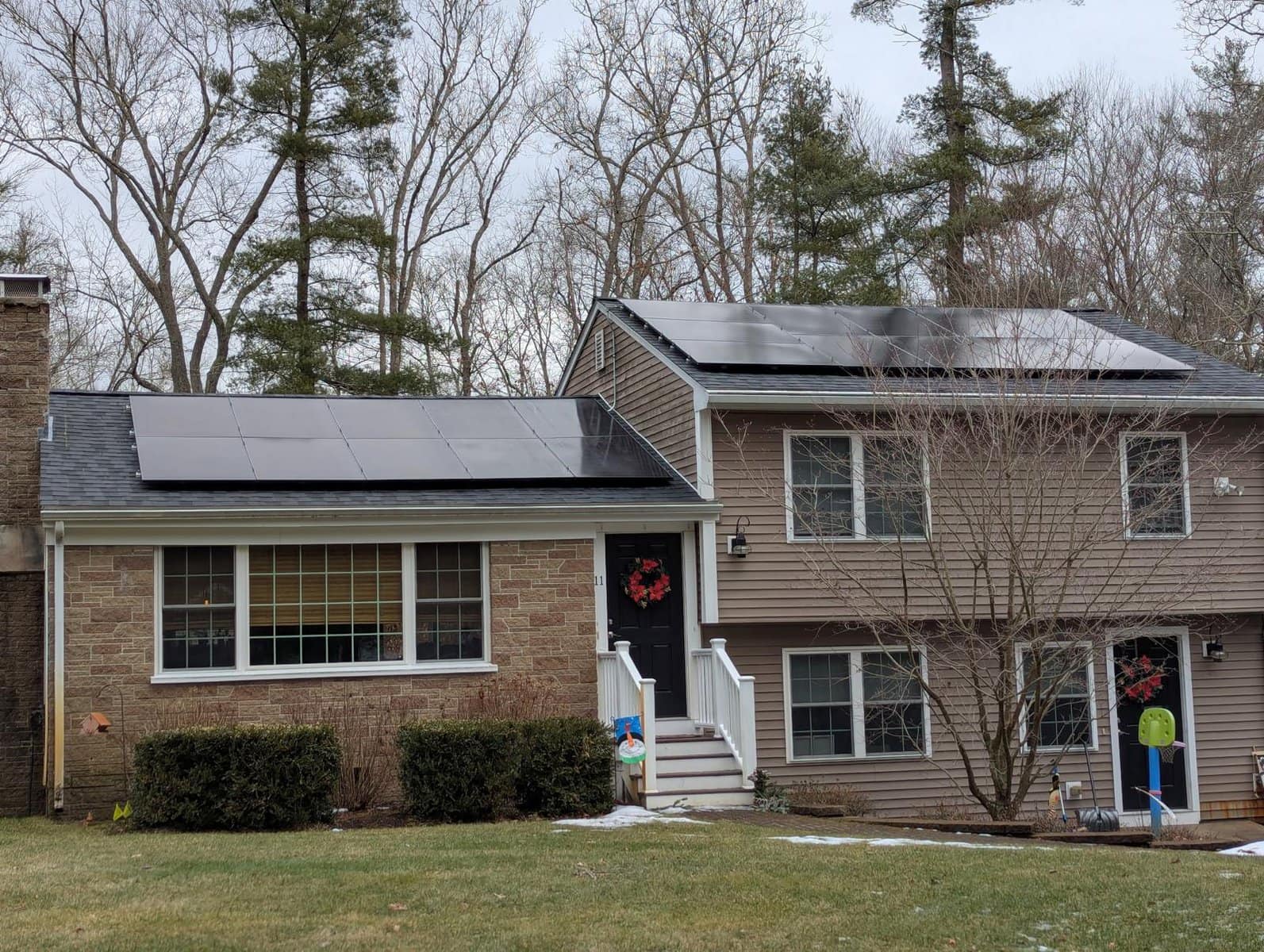Clean rooftop solar panels installed across two sections of the roof, positioned to capture consistent sunlight throughout the day. The system blends neatly with the home’s design while producing reliable, renewable energy in a practical, low-profile layout.