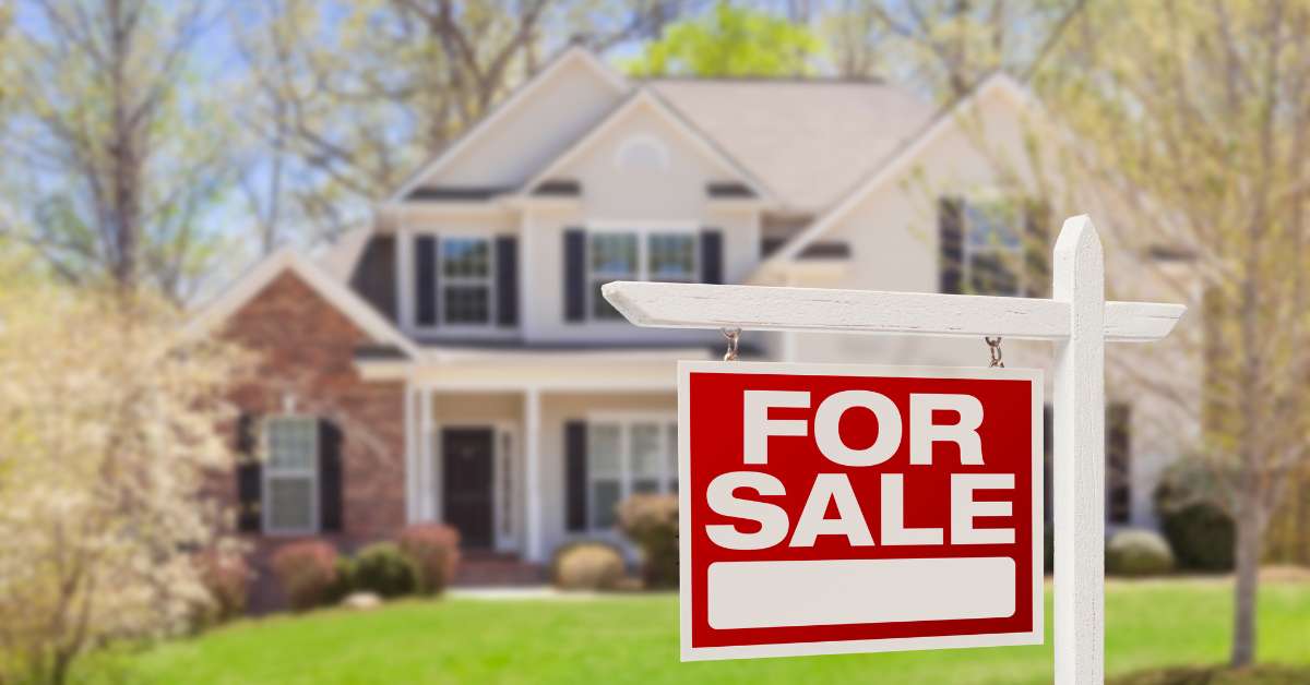 A home with solar panels on them with a for sale sign, selling at a higher value